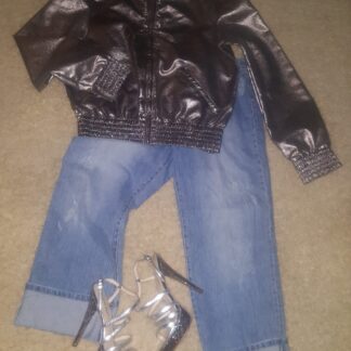 A pair of jeans and shoes are laying on the floor.