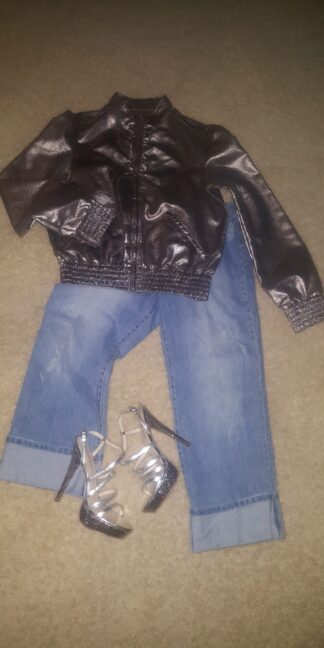 A pair of jeans and shoes are laying on the floor.