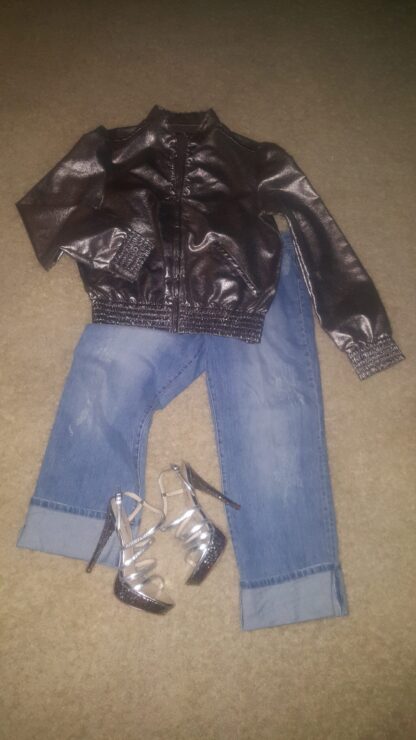 A pair of jeans and shoes are laying on the floor.