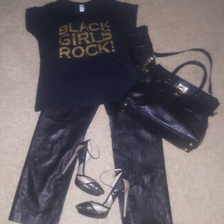 A black purse, t-shirt and leather pants.