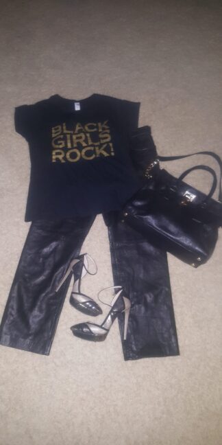 A black purse, t-shirt and leather pants.