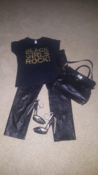 A black purse, t-shirt and leather pants.
