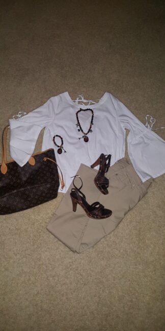 A white top, brown pants and black shoes.