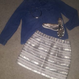 A skirt and shoes are on the floor.
