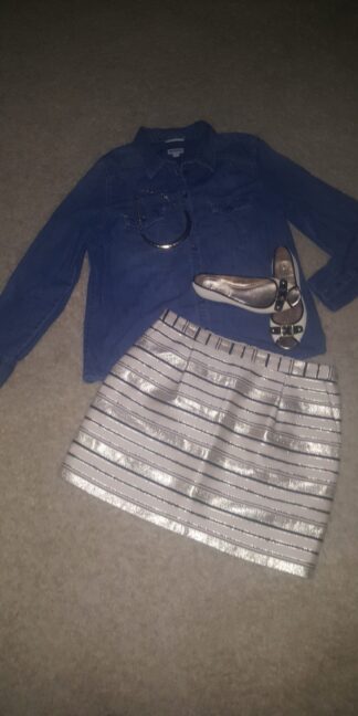 A skirt and shoes are on the floor.