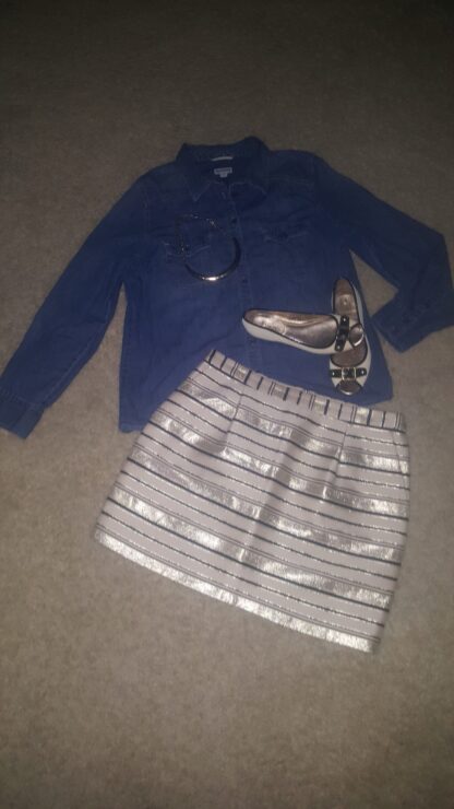 A skirt and shoes are on the floor.