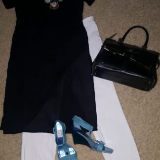 A black dress and blue shoes are on the floor.