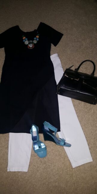 A black dress and blue shoes are on the floor.