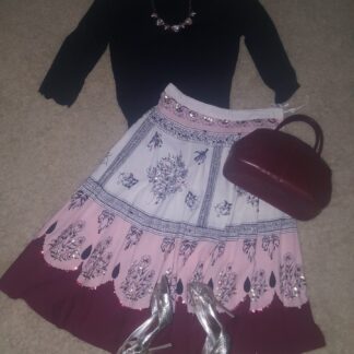 A skirt and shoes are on the floor.