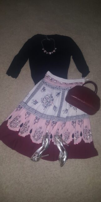 A skirt and shoes are on the floor.