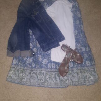 A blue dress with jeans and brown shoes on the floor