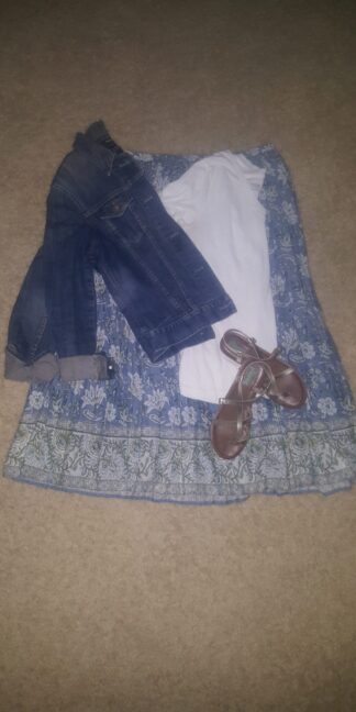 A blue dress with jeans and brown shoes on the floor