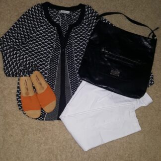 A black and white outfit with orange sandals