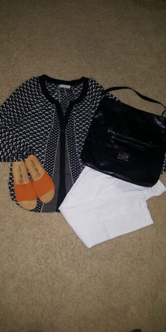 A black and white outfit with orange sandals