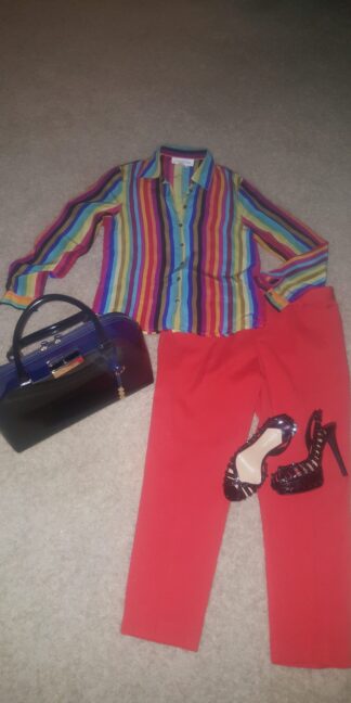A woman 's outfit with red pants and striped shirt.