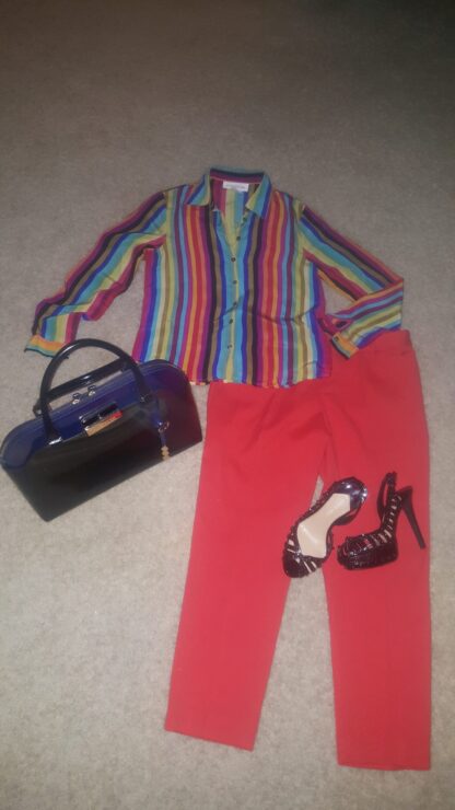 A woman 's outfit with red pants and striped shirt.