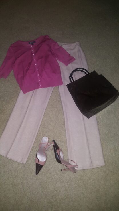 A pink shirt and white pants with shoes