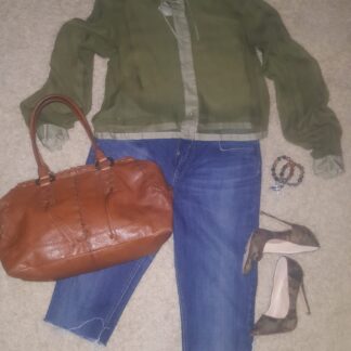 A woman 's outfit including jeans, jacket and purse.