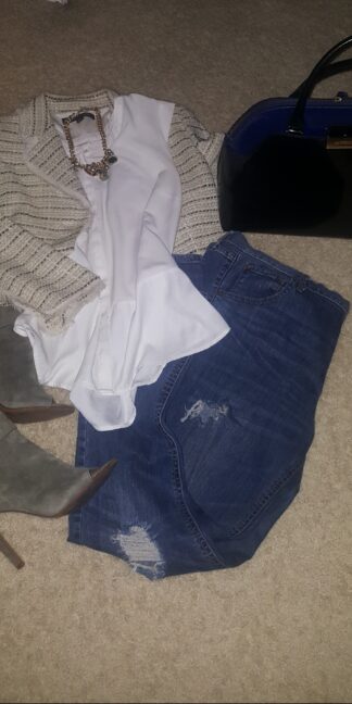 A bag of luggage and some clothes on the floor.