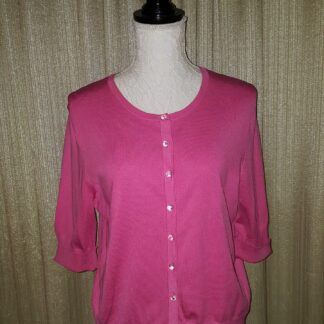 A pink sweater with a button up front.