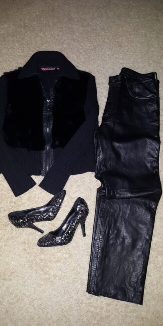 A pair of shoes and a jacket laid out on the floor.