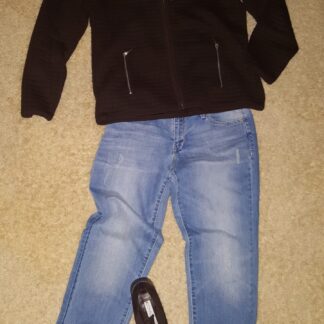 A black jacket and jeans are on the floor.