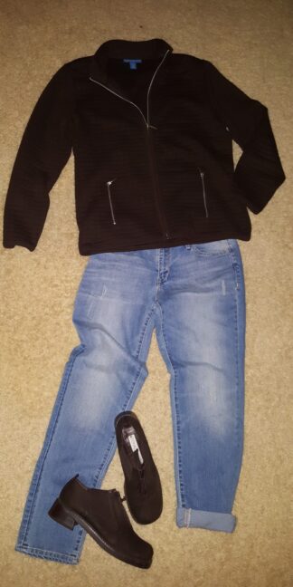 A black jacket and jeans are on the floor.