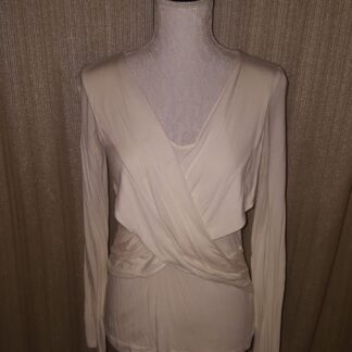 A white dress is on display against the wall.