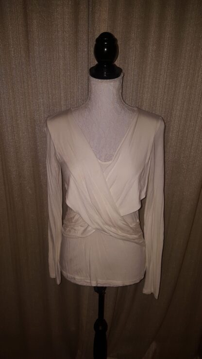A white dress is on display against the wall.